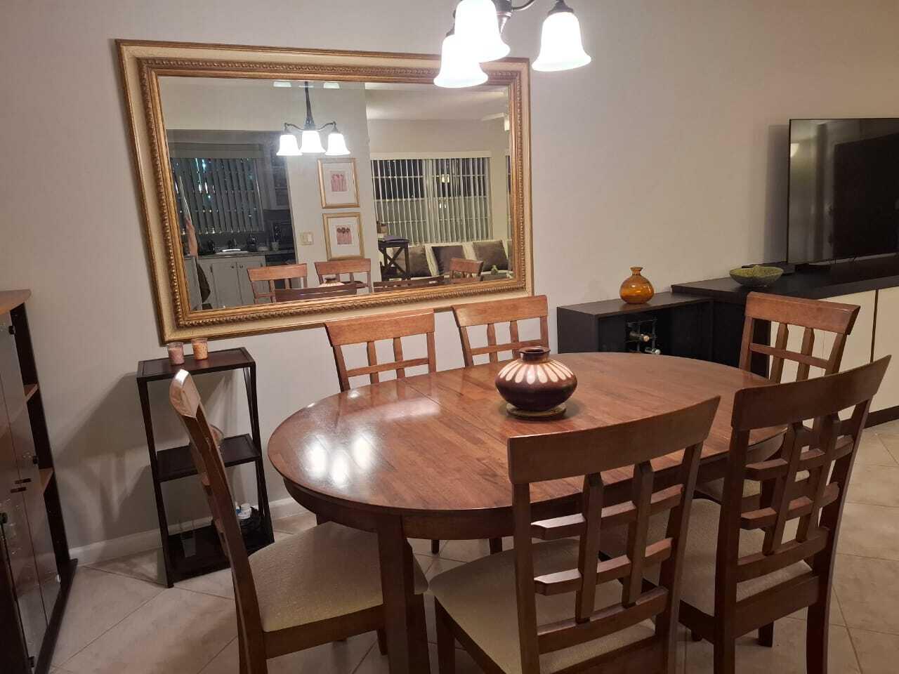 30 Oakridge C, Unit 30 Deerfield Beach, FL 33442 - Photo 12 of 12 a view of a dining room with furniture and a chandelier