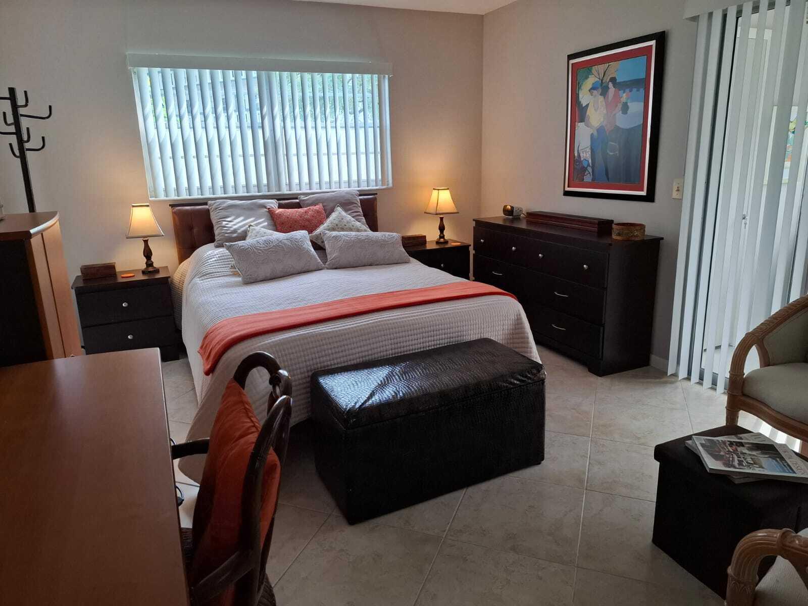 30 Oakridge C, Unit 30 Deerfield Beach, FL 33442 - Photo 2 of 12 a bedroom with a bed and wooden floor