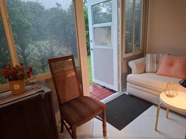 a view of sitting area with furniture and wooden floor