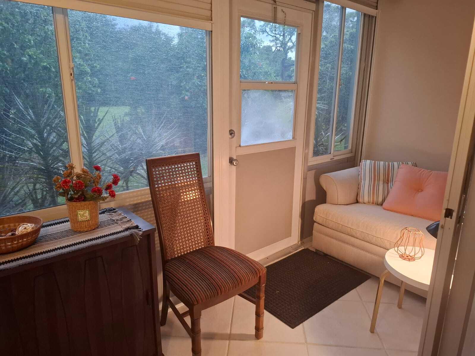 30 Oakridge C, Unit 30 Deerfield Beach, FL 33442 - Photo 6 of 12 a living room with furniture and a window