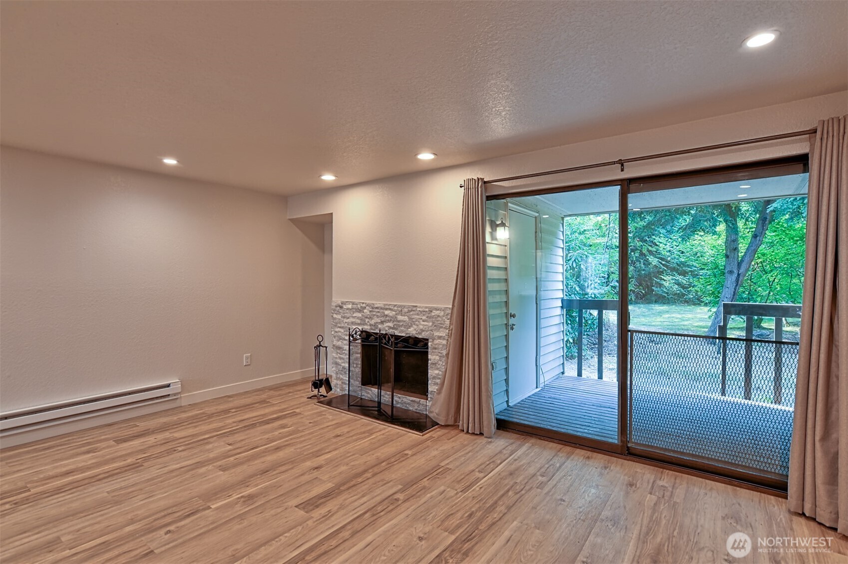 120 124th Street Southwest, Unit C8 Everett, WA 98204 - Photo 11 of 30 a view of empty room with wooden floor and fireplace