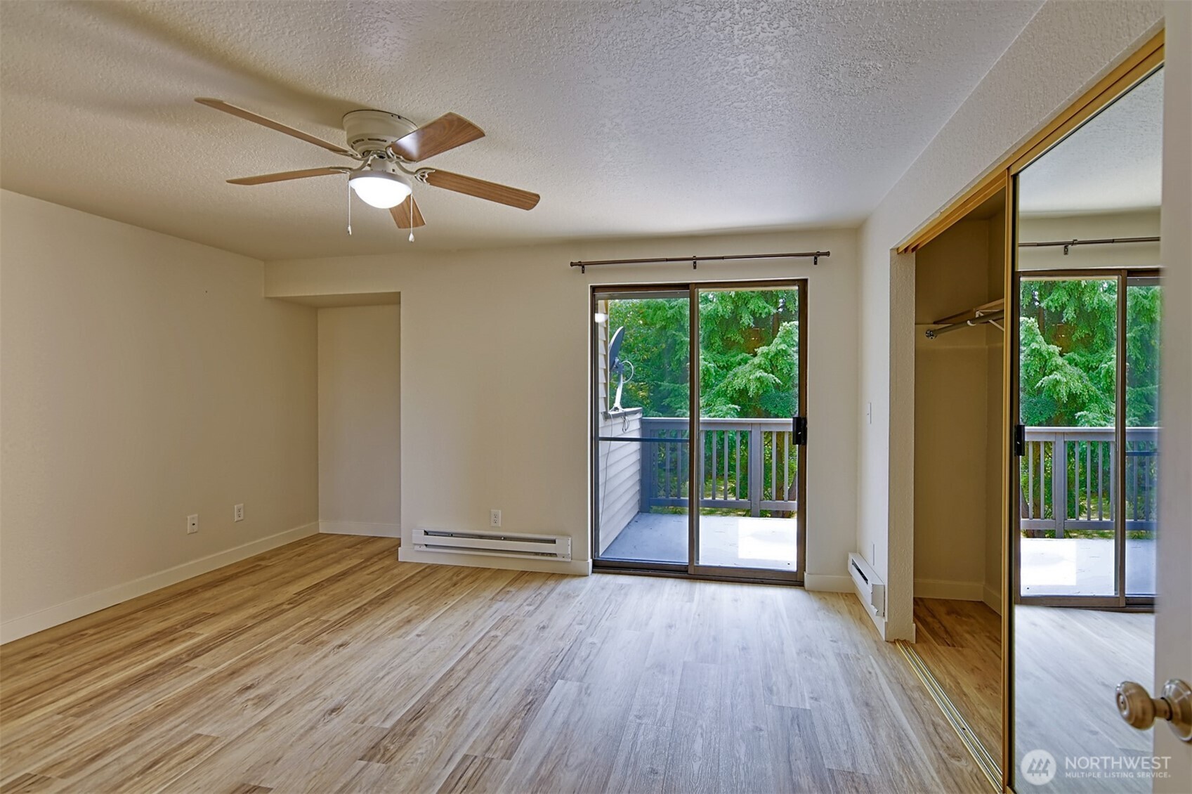 120 124th Street Southwest, Unit C8 Everett, WA 98204 - Photo 18 of 30 a view of an empty room with wooden floor and a window