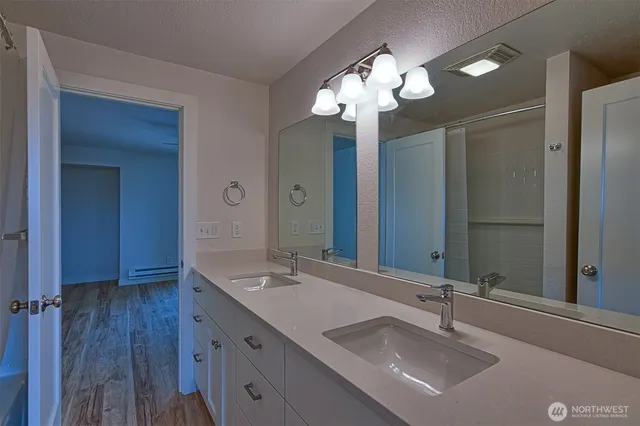 a bathroom with a sink double vanity and a mirror