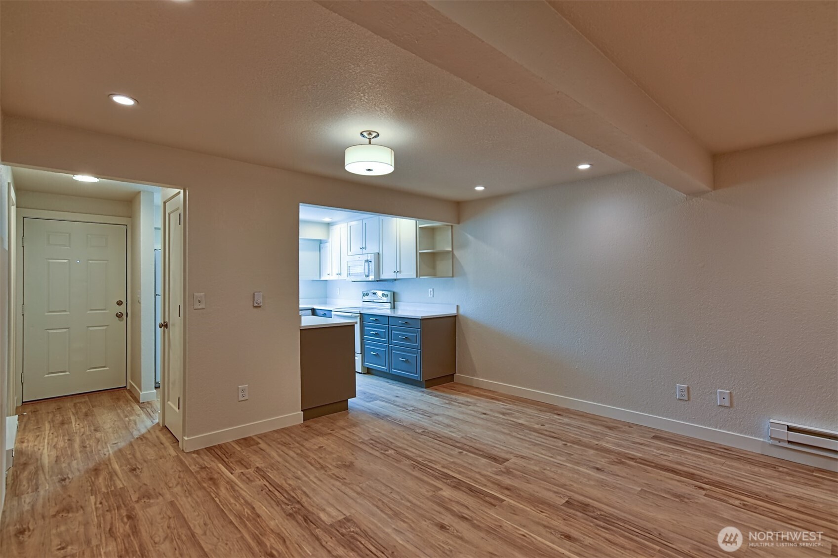 120 124th Street Southwest, Unit C8 Everett, WA 98204 - Photo 4 of 30 a view of kitchen and empty room with wooden floor