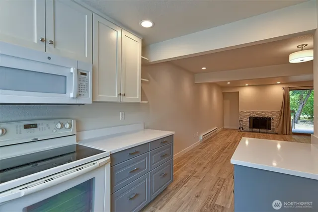 a kitchen with stainless steel appliances granite countertop a sink and a stove