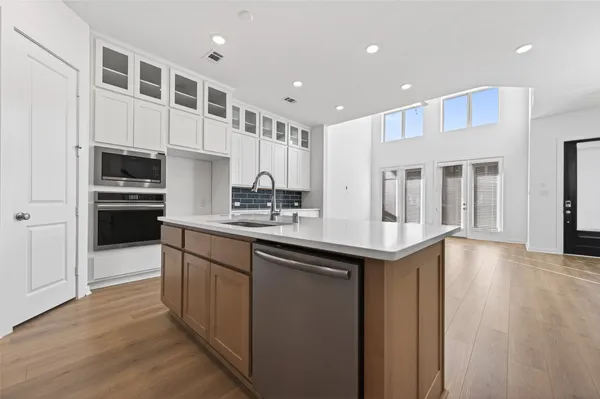 a kitchen with stainless steel appliances granite countertop a sink stove and cabinets