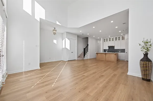 a kitchen with kitchen island a sink and wooden floor