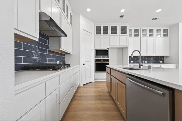 a kitchen with counter top space and windows