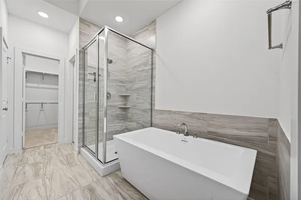 a bathroom with a granite countertop sink a mirror and shower