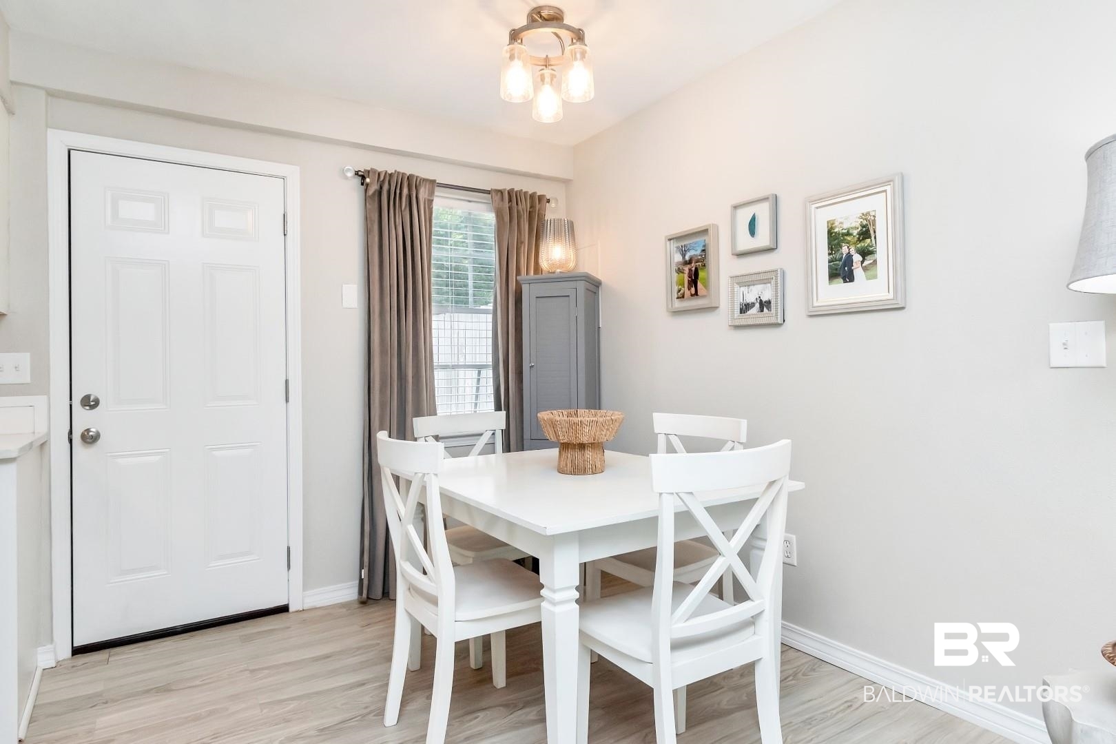 110 Du Rhu Drive, Unit C Mobile, AL 36608 - Photo 5 of 14 Dining room featuring light wood-type flooring and a notable chandelier