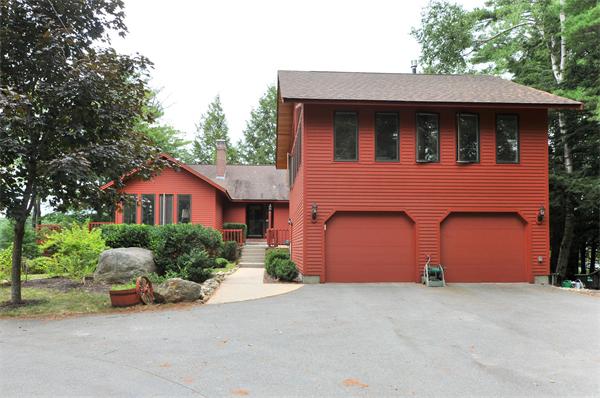 21 Island Road Ashburnham, MA 01430 - Photo 24 of 27 a front view of a house with a yard and garage