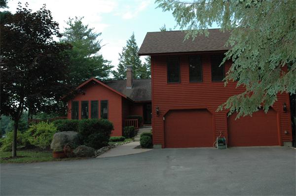 21 Island Road Ashburnham, MA 01430 - Photo 26 of 27 a front view of a house with a garden and plants