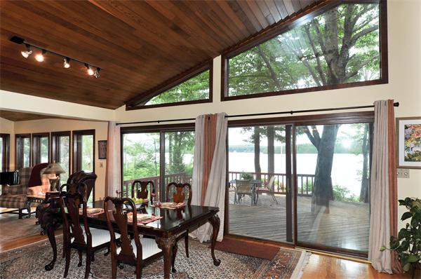 21 Island Road Ashburnham, MA 01430 - Photo 8 of 27 a view of a dining room with furniture large windows and wooden floor
