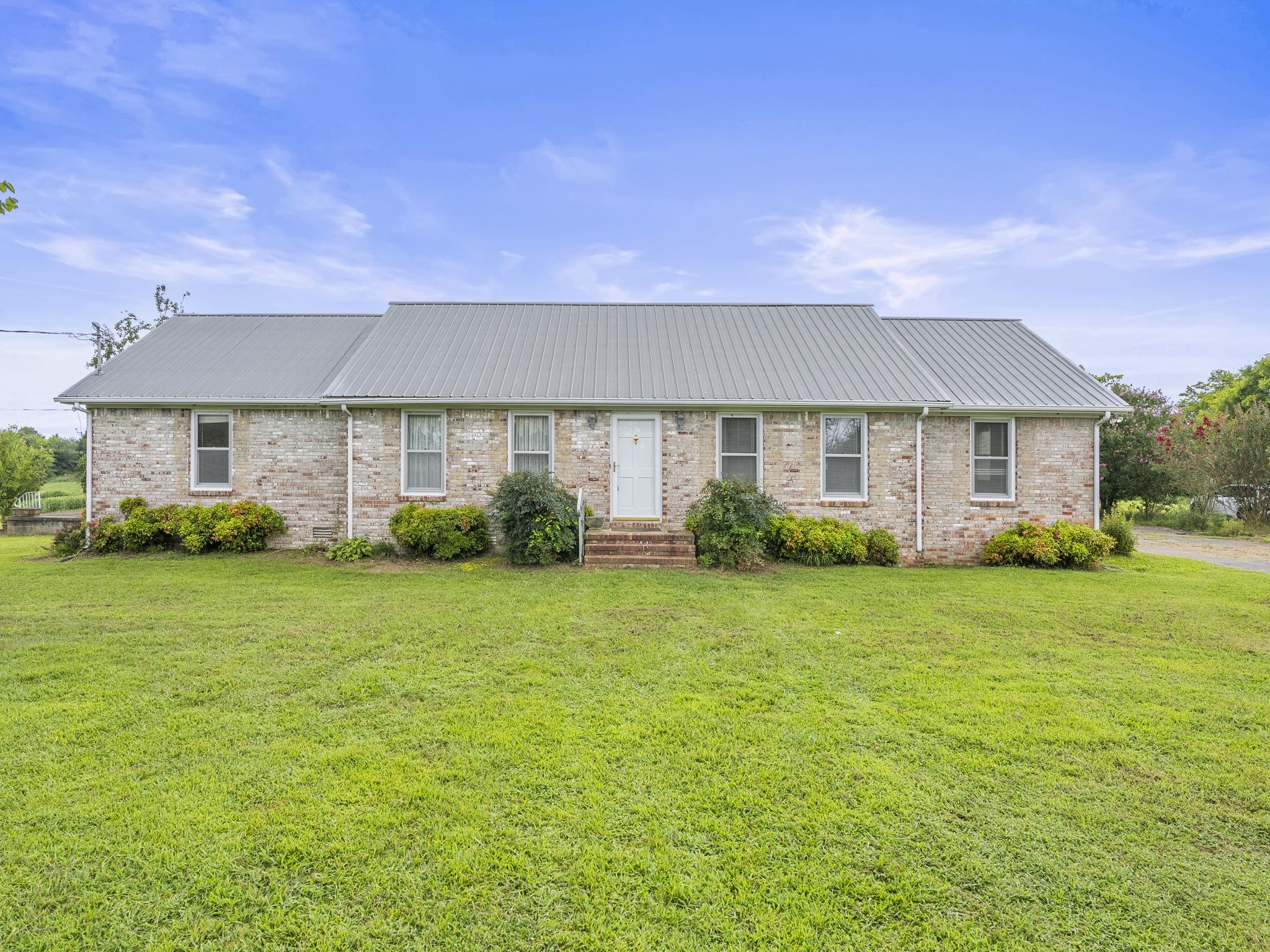 a front view of a house with garden
