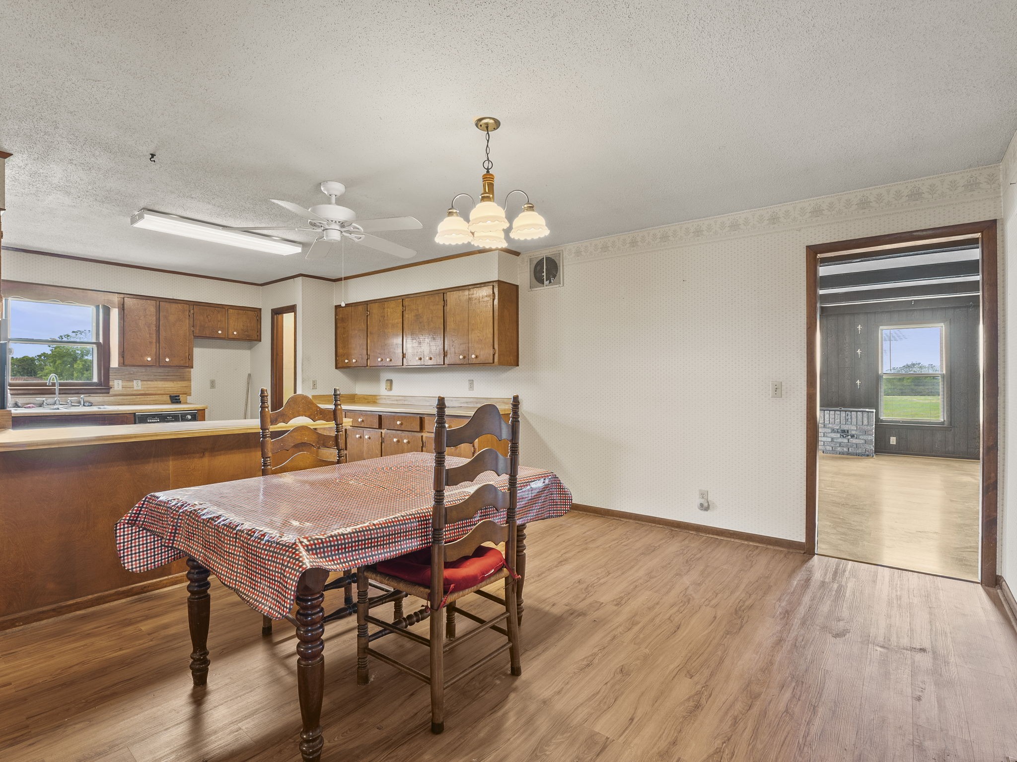 161 Stewarts Chapel Road Flintville, TN 37335 - Photo 26 of 39 a dining room with wooden floor a chandelier a wooden table and chairs