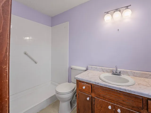 a bathroom with a toilet sink and mirror
