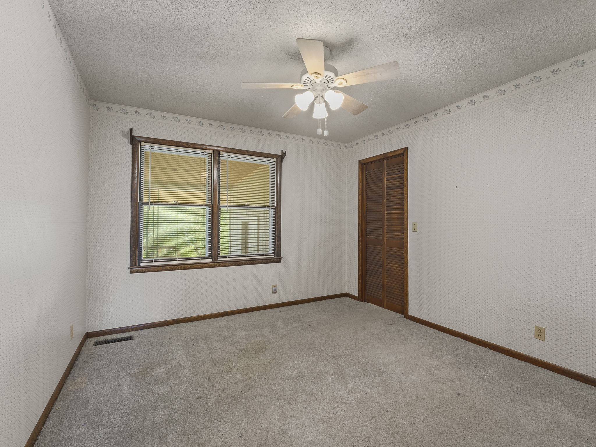 161 Stewarts Chapel Road Flintville, TN 37335 - Photo 36 of 39 an empty room with windows and chandelier fan