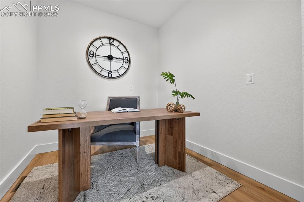 12955 Sunrise Ridge Drive Peyton, CO 80831 - Photo 27 of 49 a view of a room with a table and chairs