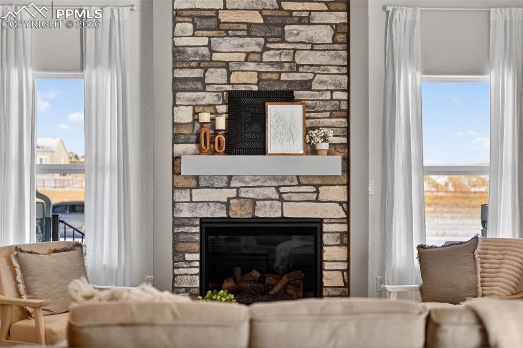 12955 Sunrise Ridge Drive Peyton, CO 80831 - Photo 3 of 49 a living room with furniture and a fireplace