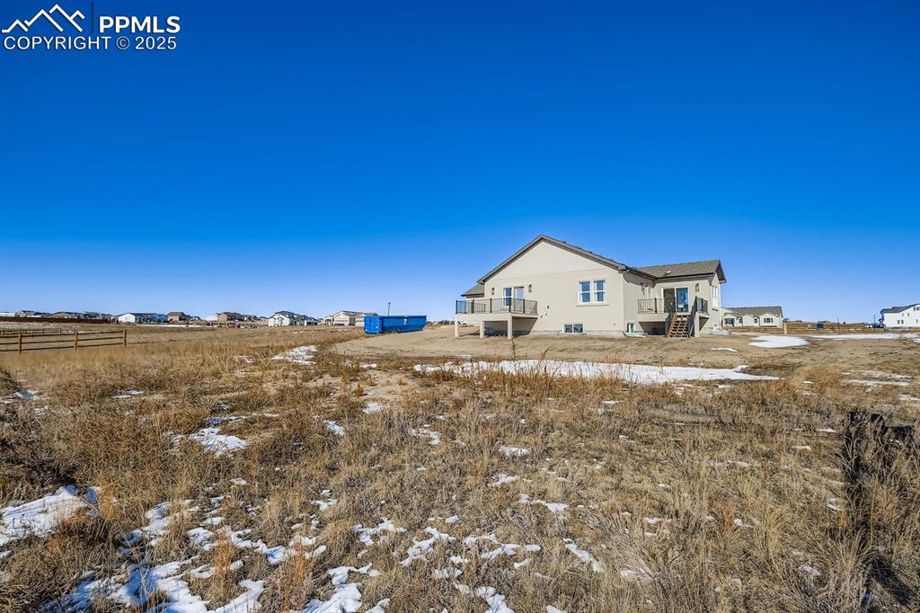 12955 Sunrise Ridge Drive Peyton, CO 80831 - Photo 47 of 49 a view of house with yard and mountain view in back