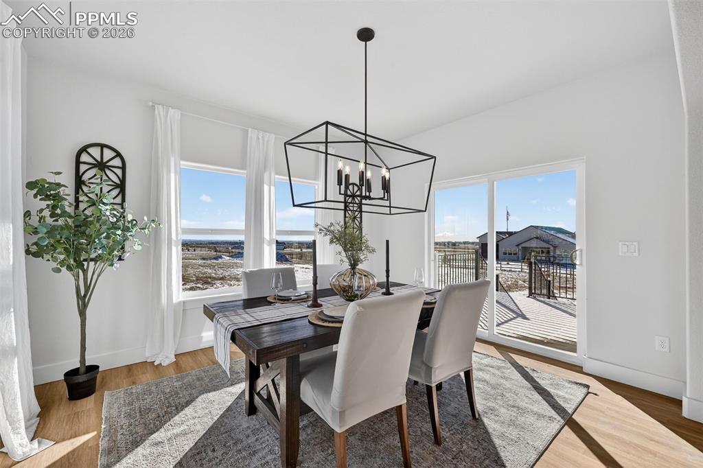 12955 Sunrise Ridge Drive Peyton, CO 80831 - Photo 6 of 49 a view of a dining room with furniture and a potted plant