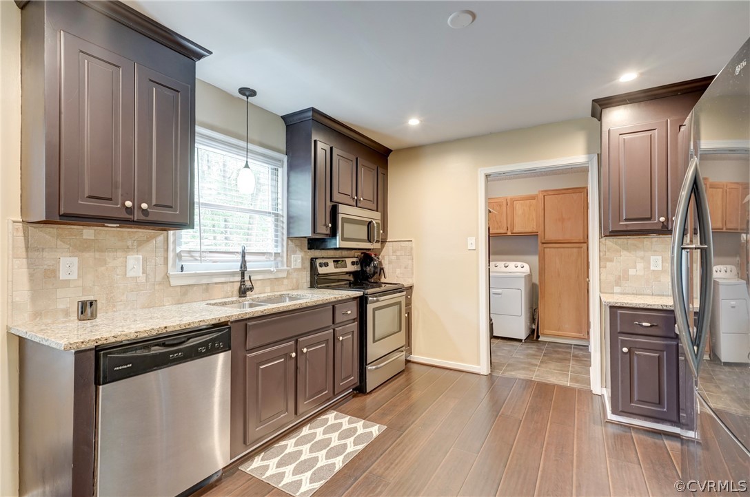 10618 Ridgerun Road Chesterfield, VA 23832 - Photo 11 of 36 a kitchen with stainless steel appliances granite countertop a refrigerator a sink dishwasher and wooden cabinets with wooden floor