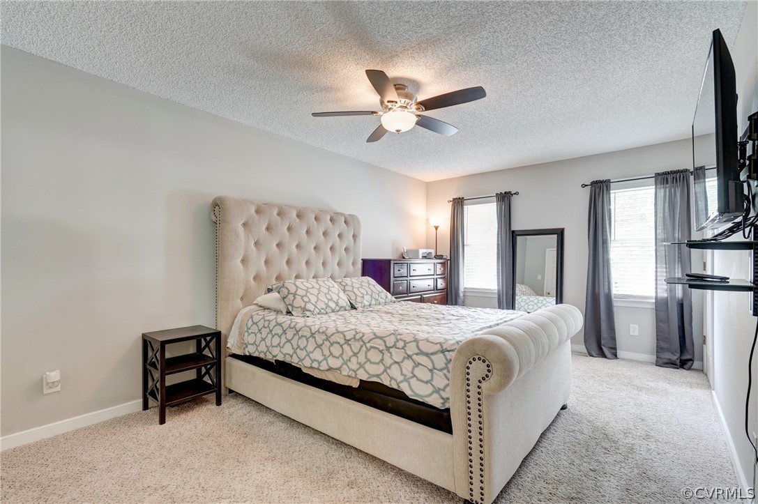 10618 Ridgerun Road Chesterfield, VA 23832 - Photo 17 of 36 a bedroom with a bed and a chandelier
