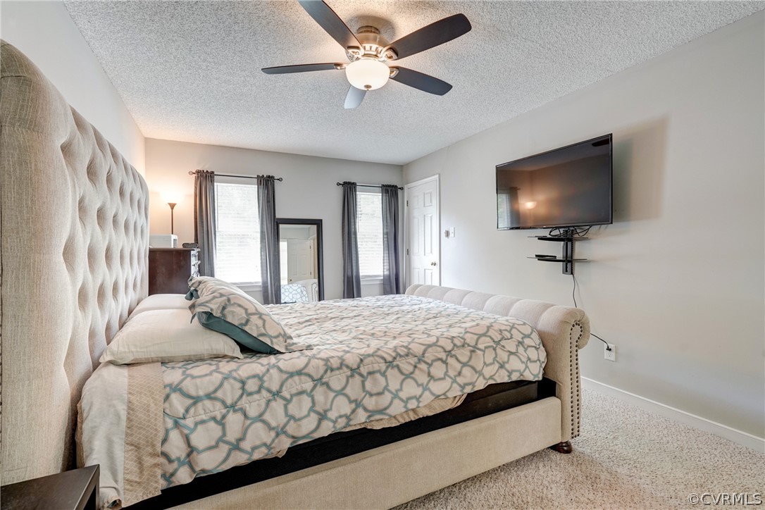 10618 Ridgerun Road Chesterfield, VA 23832 - Photo 18 of 36 a bedroom with a bed window and a chandelier