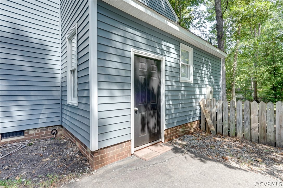 10618 Ridgerun Road Chesterfield, VA 23832 - Photo 31 of 36 a wooden house with a large window and wooden fence