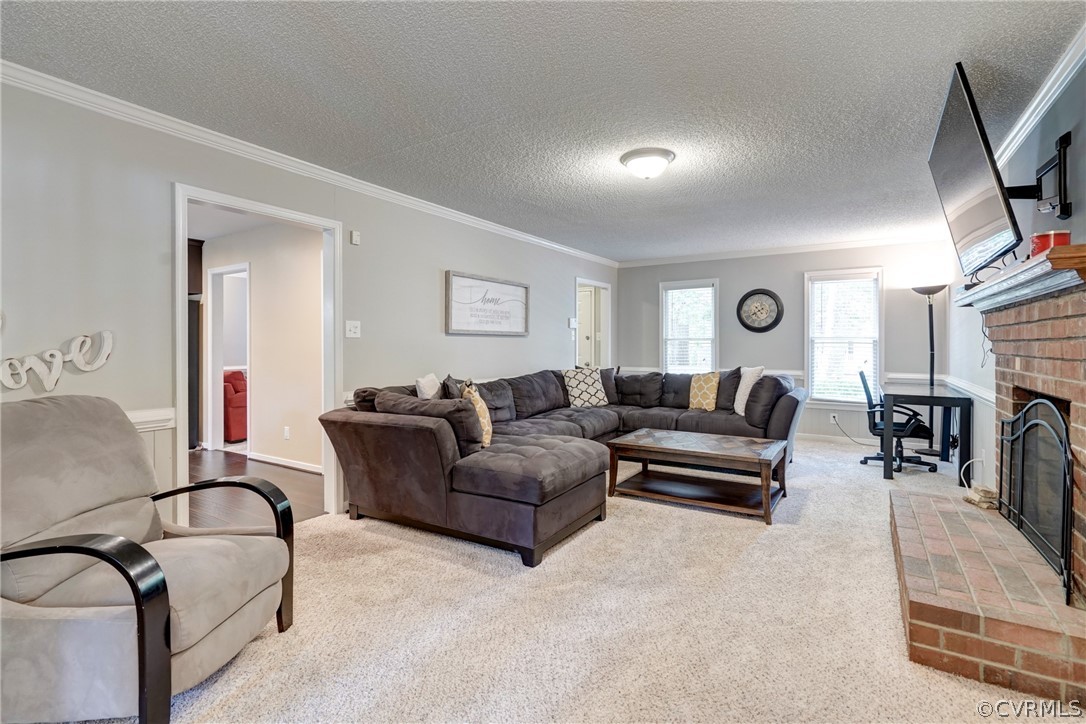 10618 Ridgerun Road Chesterfield, VA 23832 - Photo 7 of 36 a living room with furniture a fireplace and a flat screen tv