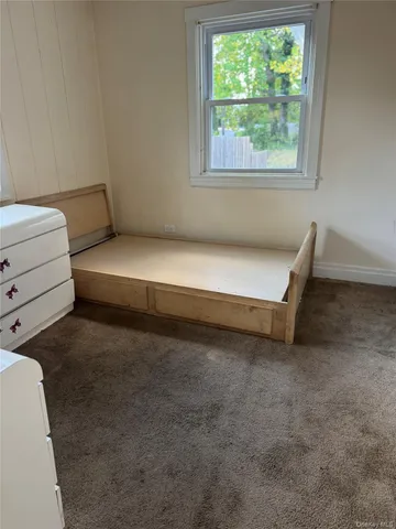 a room with a bed and a window