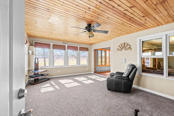 a spacious bedroom with a bed and a chandelier