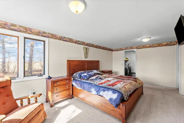 a bedroom with a bed and window