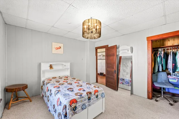 a bedroom with a bed and a chandelier