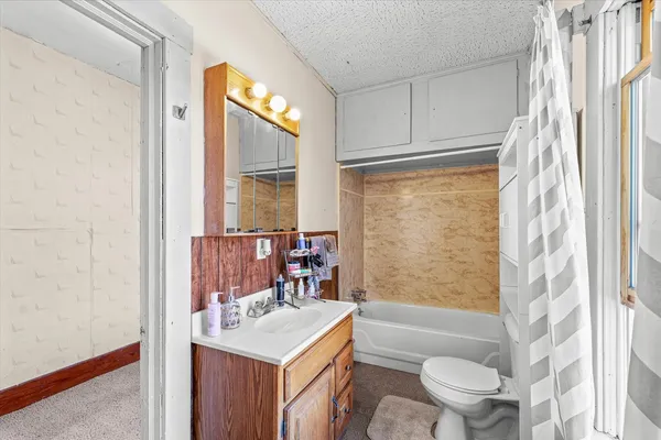 a bathroom with a sink toilet tub and shower