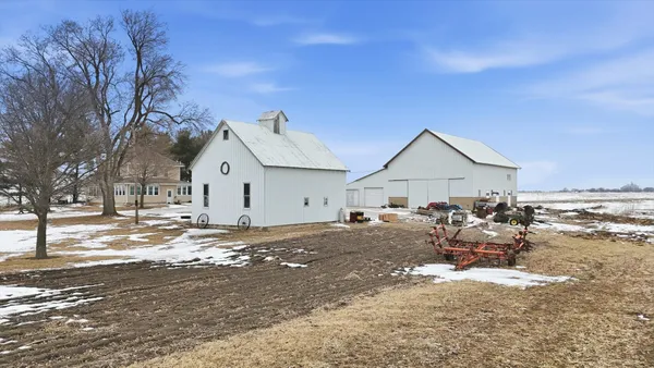 a view of a house with wooden fence