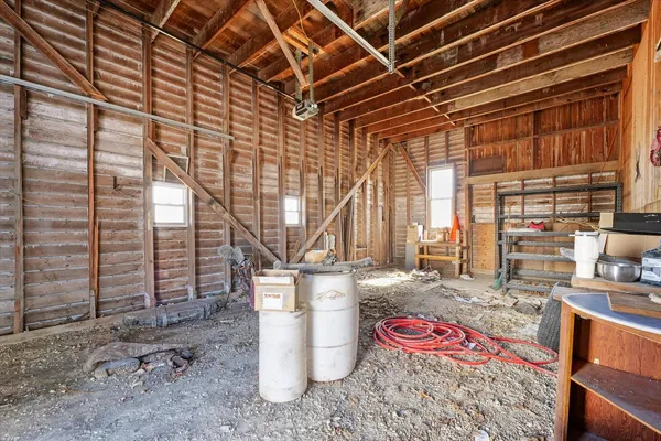 a storage room with water heater and wooden walls
