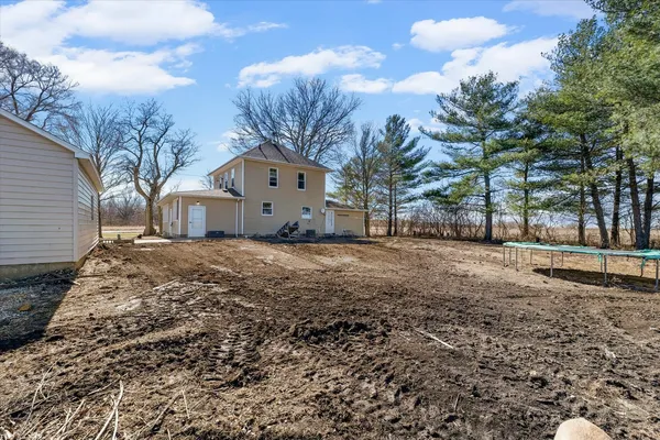 a front view of a house with a yard covered in snow