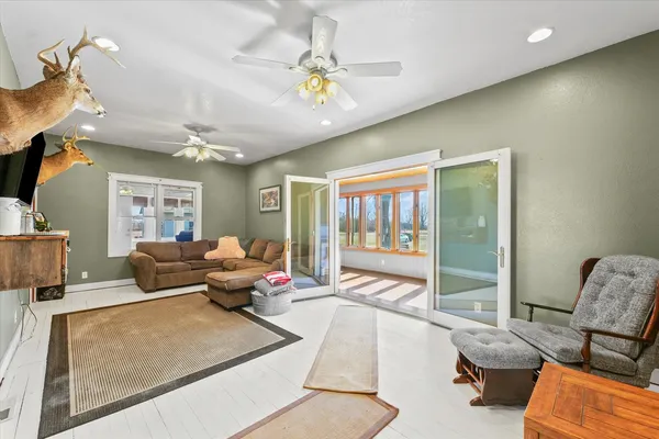 a living room with furniture and a chandelier