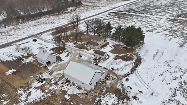 a aerial view of a house with a yard