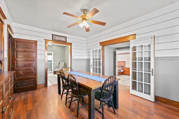 a view of a dining room with furniture and wooden floor