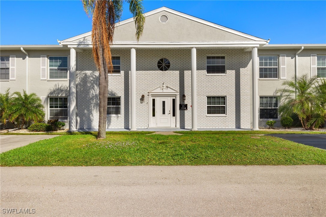 7068 Nantucket Circle, Unit 3 North Fort Myers, FL 33917 - Photo 1 of 17 a front view of a house with a yard
