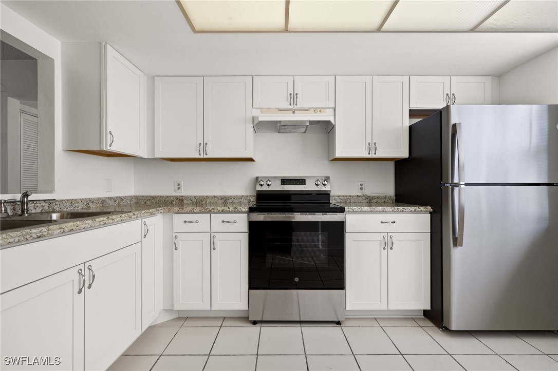 7068 Nantucket Circle, Unit 3 North Fort Myers, FL 33917 - Photo 9 of 17 a kitchen with cabinets stainless steel appliances and a sink