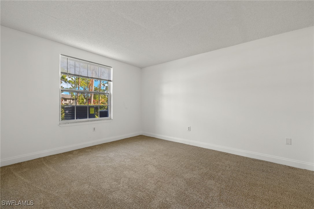 7068 Nantucket Circle, Unit 3 North Fort Myers, FL 33917 - Photo 10 of 17 an empty room with a window