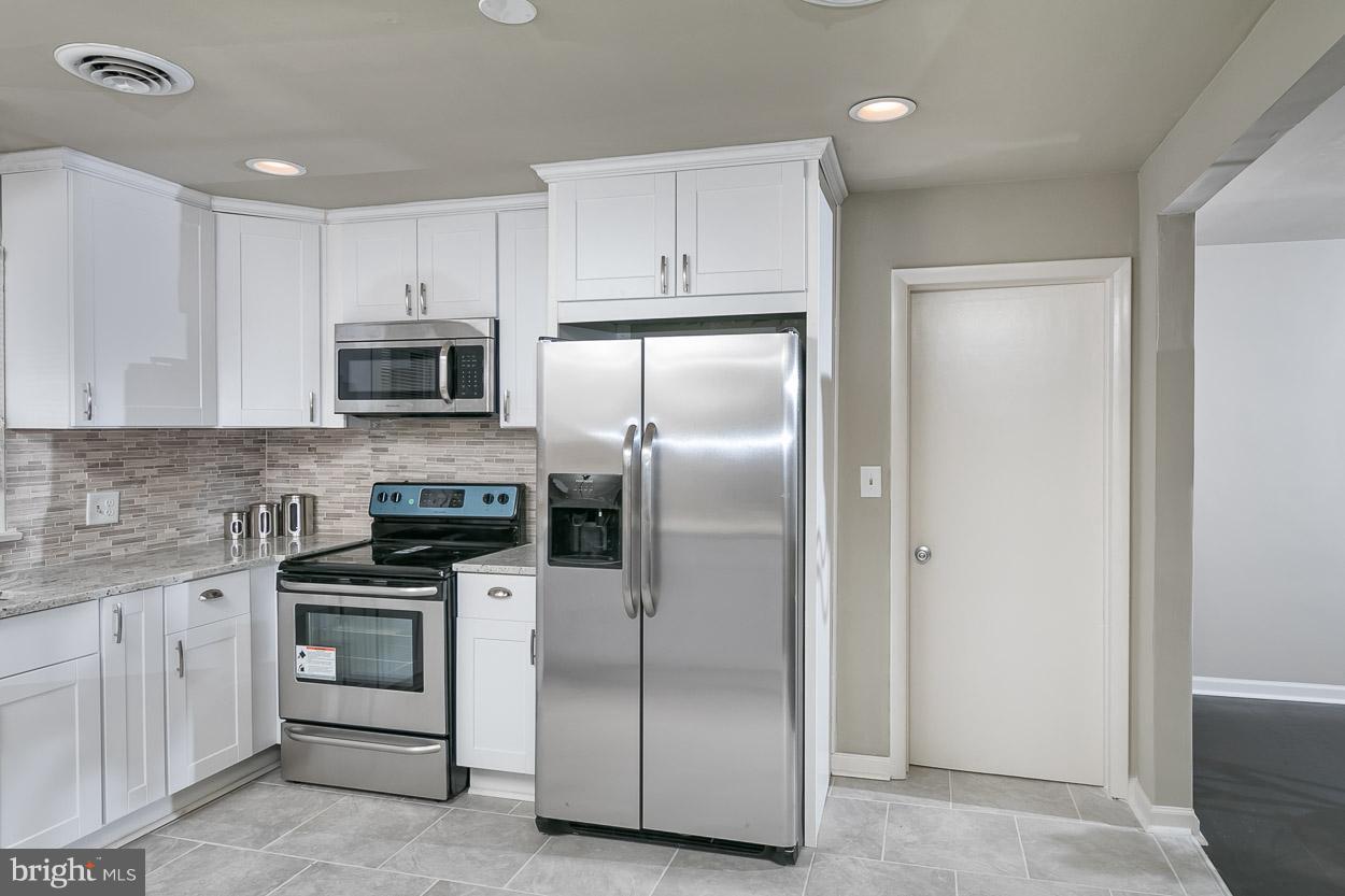 2801 Page Court Fallston, MD 21047 - Photo 17 of 30 a kitchen with white cabinets and stainless steel appliances