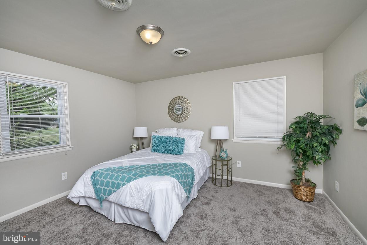2801 Page Court Fallston, MD 21047 - Photo 20 of 30 a bedroom with a bed and a potted plant