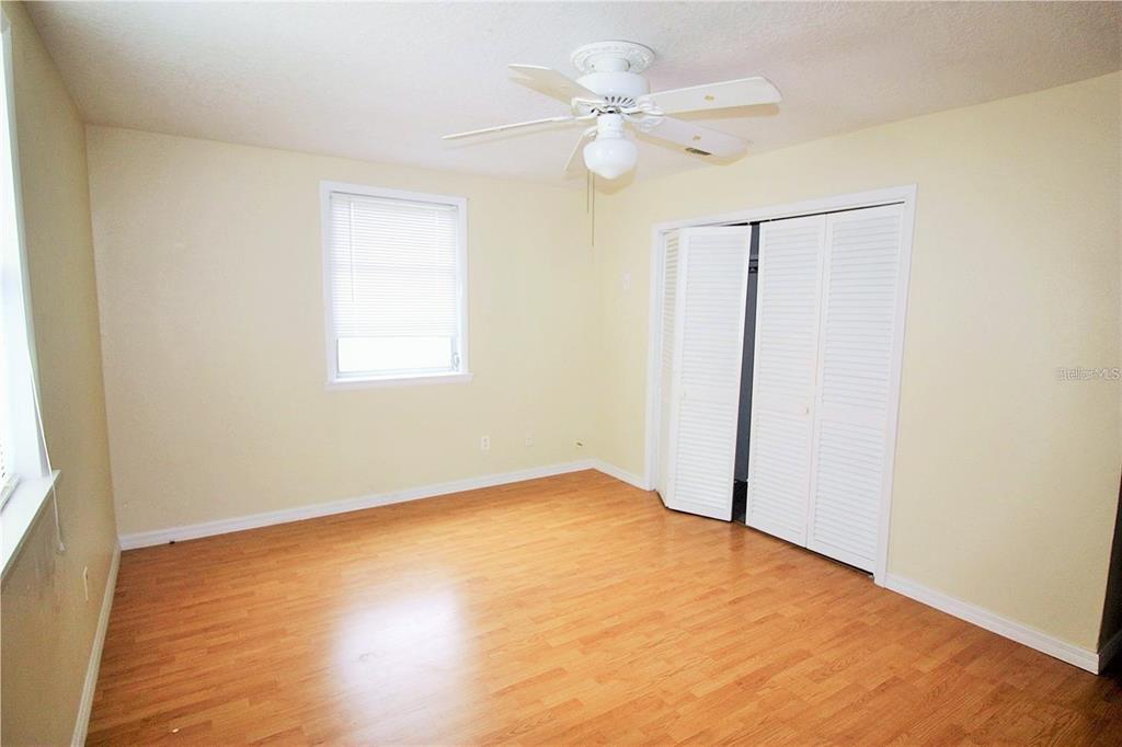 521 20th Street Southwest, Unit C Winter Haven, FL 33880 - Photo 9 of 18 an empty room with a window and a fan