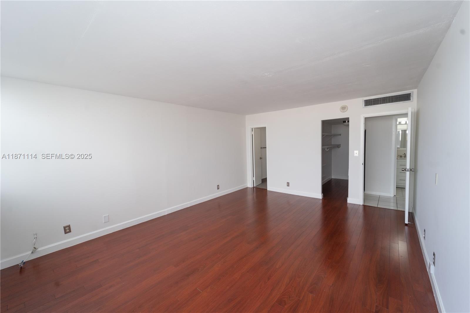 100 Golden Isles Drive, Unit 809 Hallandale Beach, FL 33009 - Photo 13 of 18 a view of an empty room and wooden floor