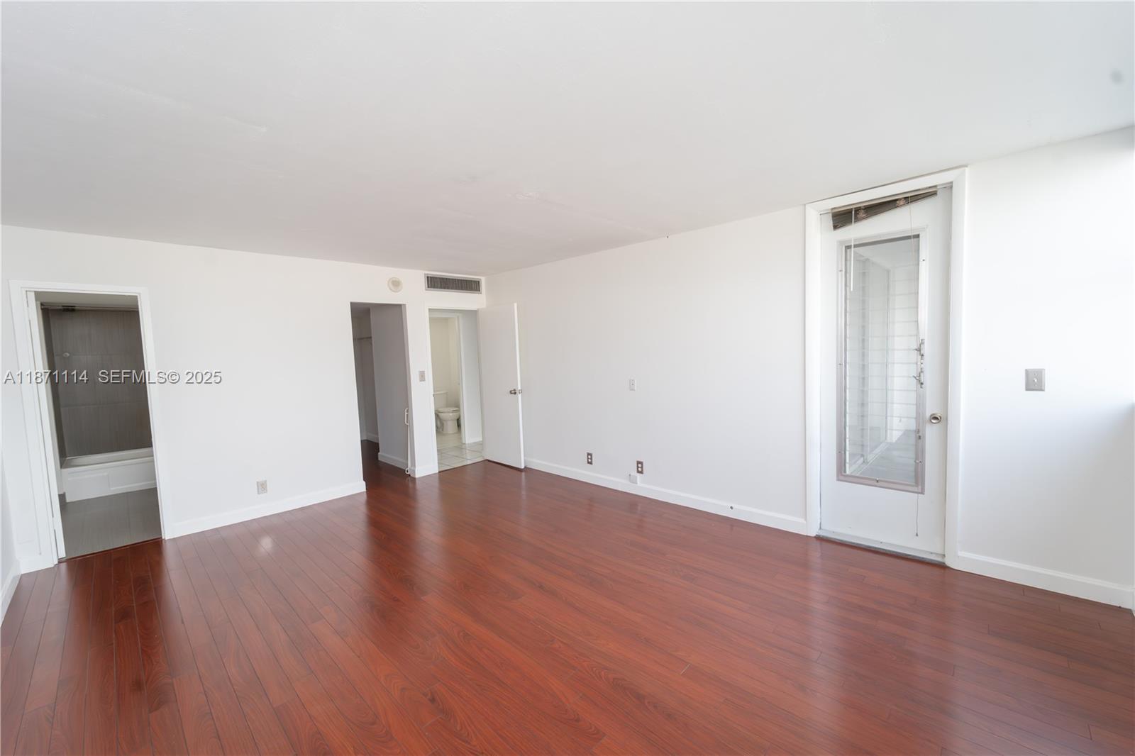 100 Golden Isles Drive, Unit 809 Hallandale Beach, FL 33009 - Photo 14 of 18 a view of an empty room with wooden floor and closet