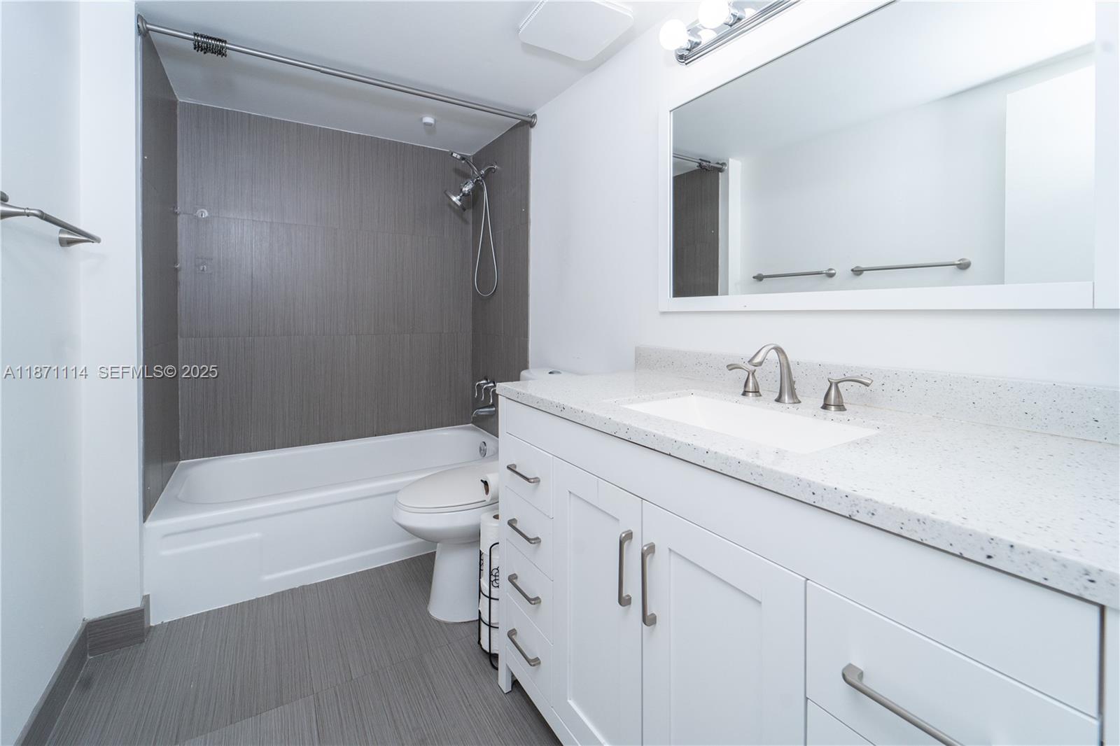 100 Golden Isles Drive, Unit 809 Hallandale Beach, FL 33009 - Photo 16 of 18 a bathroom with a sink a toilet and bathtub